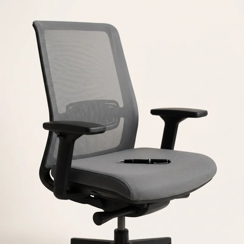 An empty office chair, a fountain pen resting on the seat